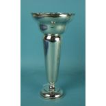A tall trumpet shaped silver vase with cast wavy rim and loaded base, 24.5cm high, Birmingham 1911.