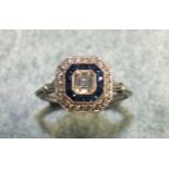 A diamond and sapphire cluster ring set an Asscher-cut diamond of approximately 0.45cts, with