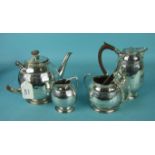 A Liberty & Co. four-piece tea service of rounded form, with embossed decoration, on beaded circular