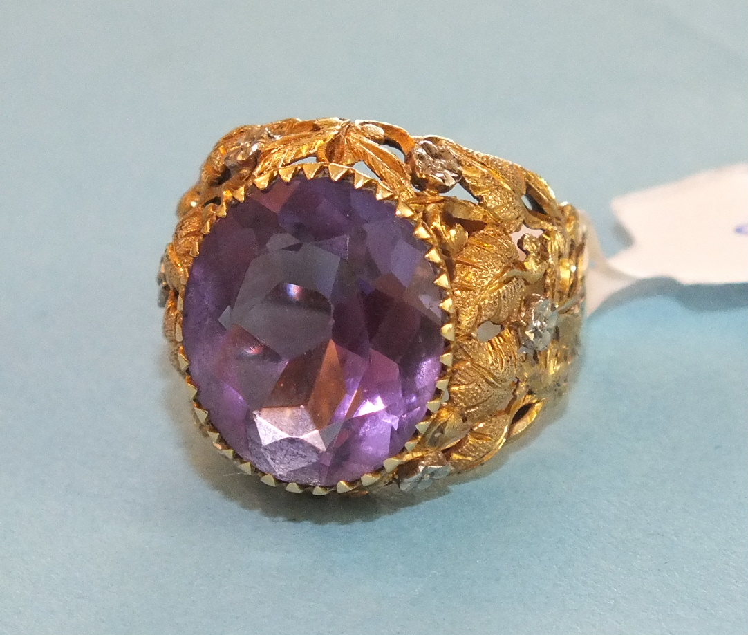 An amethyst dress ring set an oval amethyst in 18ct gold yellow and white gold mount, pierced and