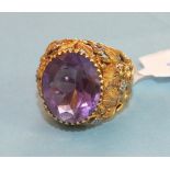 An amethyst dress ring set an oval amethyst in 18ct gold yellow and white gold mount, pierced and
