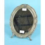A modern Continental dressing table mirror, the oval frame with scrolling foliate border and wood