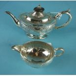 A Victorian silver bachelor teapot and milk jug by Martin Hall & Co, of squat oval form, with