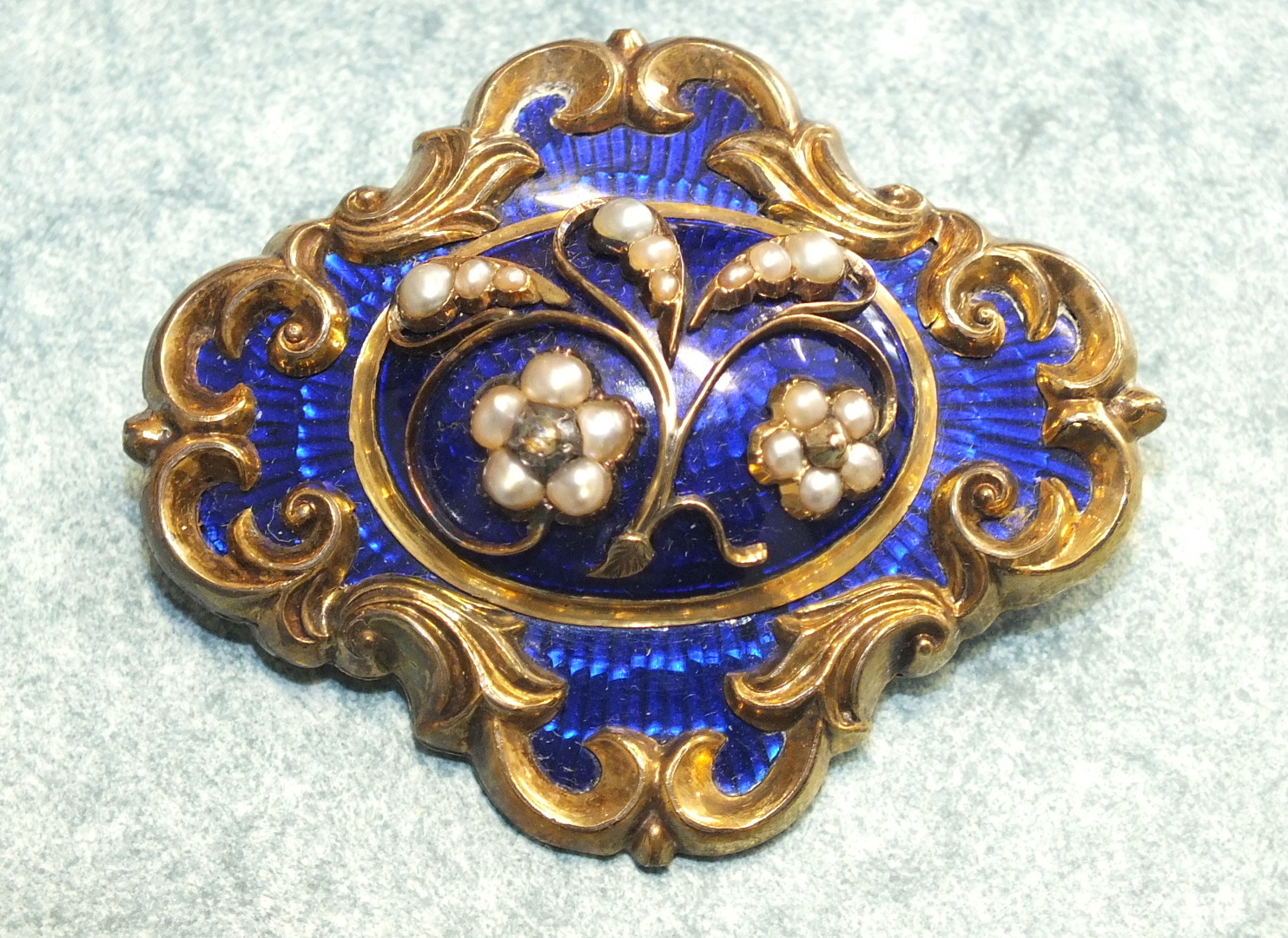 A Victorian blue enamel, split pearl and diamond mourning brooch with pearl and rose cut diamond