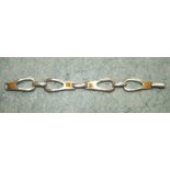 A silver Scandinavian silver style bracelet of rounded stirrup shaped links inset yellow squares,