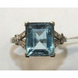 An Art Deco aquamarine and diamond ring claw-set a rectangular-cut aquamarine of approximately