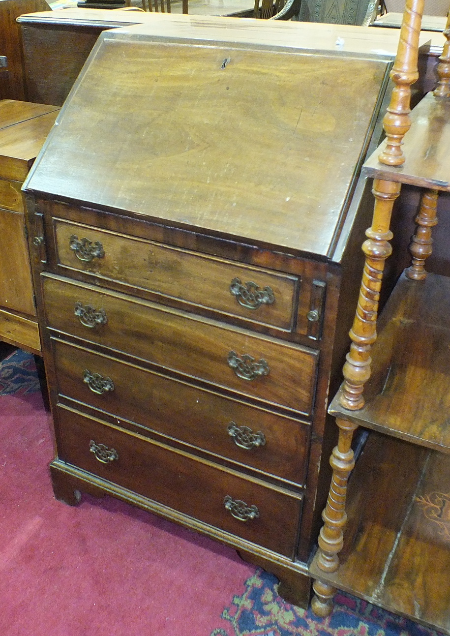 A late-19th/early-20th century bureau, the rectangular top with fall front above four drawers, on