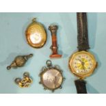 A small 9ct gold faced locket, an agate seal, a gold cased wrist watch and other items.