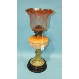 A Victorian brass oil lamp with etched frilly glass shade and moulded glass reservoir, raised on a