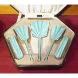 A cased five-piece pale green enamelled silver dressing table brush set, Birmingham 1931.