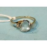 A 14k white gold cross-over ring set an oval aquamarine and two diamond points, size L½, 2.8g.