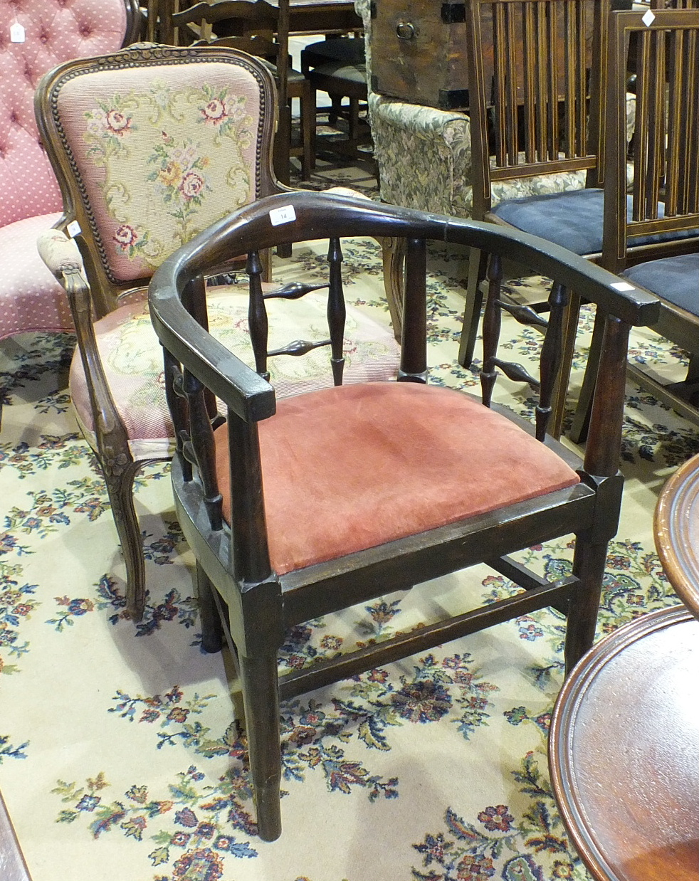An Edwardian stained wood elbow chair and a stained-wood-framed partially-padded armchair with