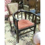 An Edwardian stained wood elbow chair and a stained-wood-framed partially-padded armchair with