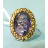 A 9ct gold ring set a large amethyst within a surround of seed pearls, size M, 6.2g.