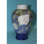 A large Royal Doulton baluster stoneware vase with tubeline decoration of roses and foliate