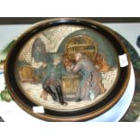 A Musterschutz painted relief-decorated pottery plaque depicting monks in a wine cellar, 34cm