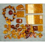 A quantity of honey coloured faux amber beads, plaques etc.