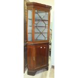 An inlaid mahogany corner cupboard, the upper section fitted with a single astragal-glazed door