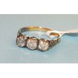 A three-stone diamond ring the brilliant cut diamonds in unmarked gold mount, size N, 2.2g.