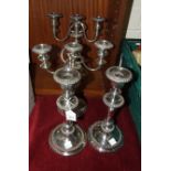 A pair of embossed plated copper three-light candelabra, 32cm high and a pair of plated candlesticks