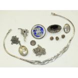 A white metal floral brooch set a sapphire and synthetic white stones, (tests as white gold), a