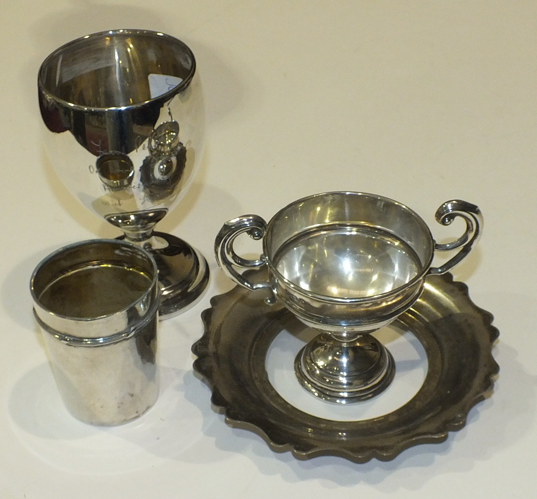 A small quantity of silver, comprising a goblet, small trophy cup, beaker and butter dish (no