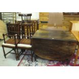 An oak drop-leaf table on barley-twist supports, 177 x 104cm open, four oak-framed dining chairs,