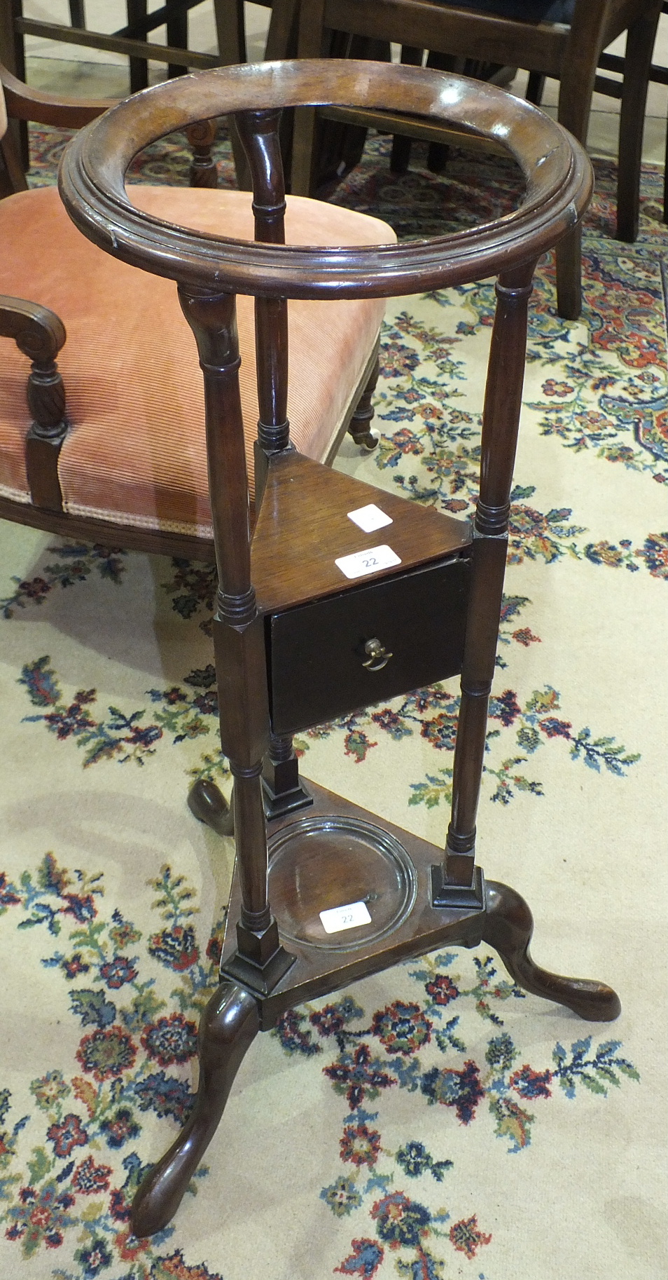 A 19th century mahogany wash stand, the circular top with inset for bowl, above a single drawer,