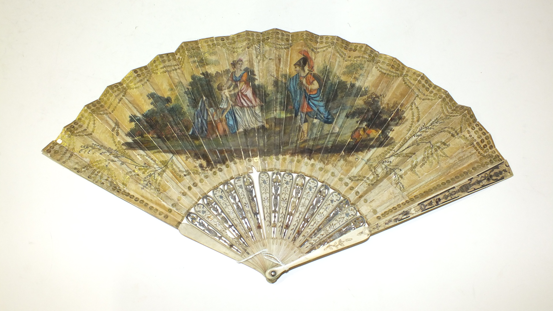 An 18th century fan, the guards and sticks carved and heightened in gold and silver, the chicken