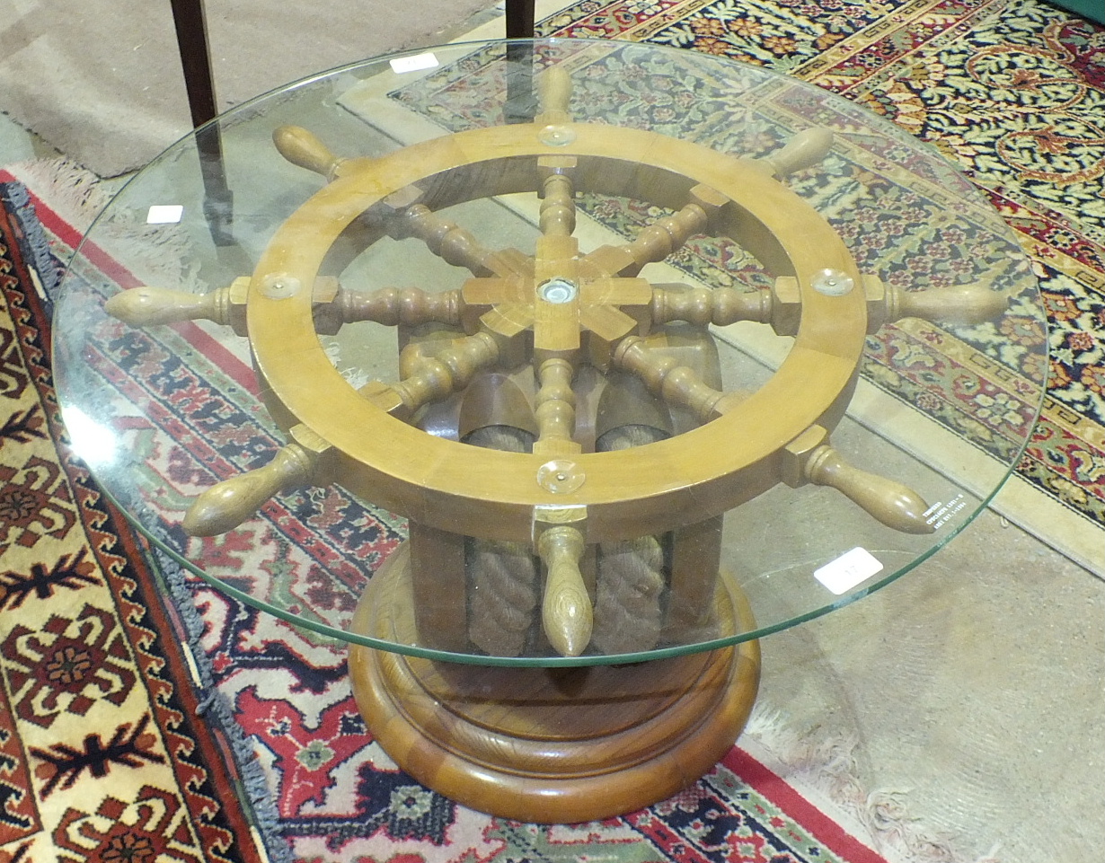 A circular glass-top ship's wheel coffee table on rope pulley stand and circular base, 70cm