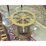 A circular glass-top ship's wheel coffee table on rope pulley stand and circular base, 70cm