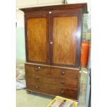 A 19th century mahogany linen press, the cornice above a pair of doors revealing two slides, the
