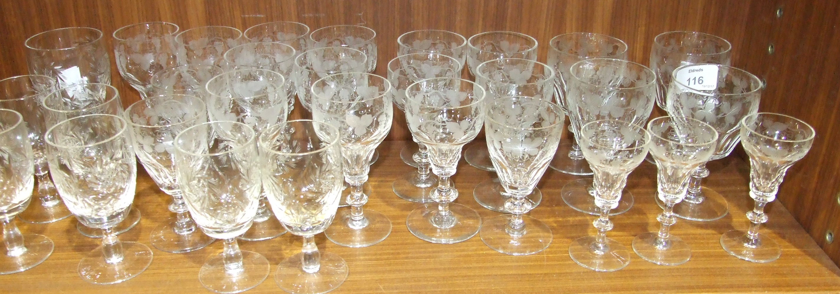 A collection of Stuart crystal and other etched Port glasses and liqueur glasses.