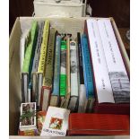 A painted metal railway lamp and a small collection of railway books.