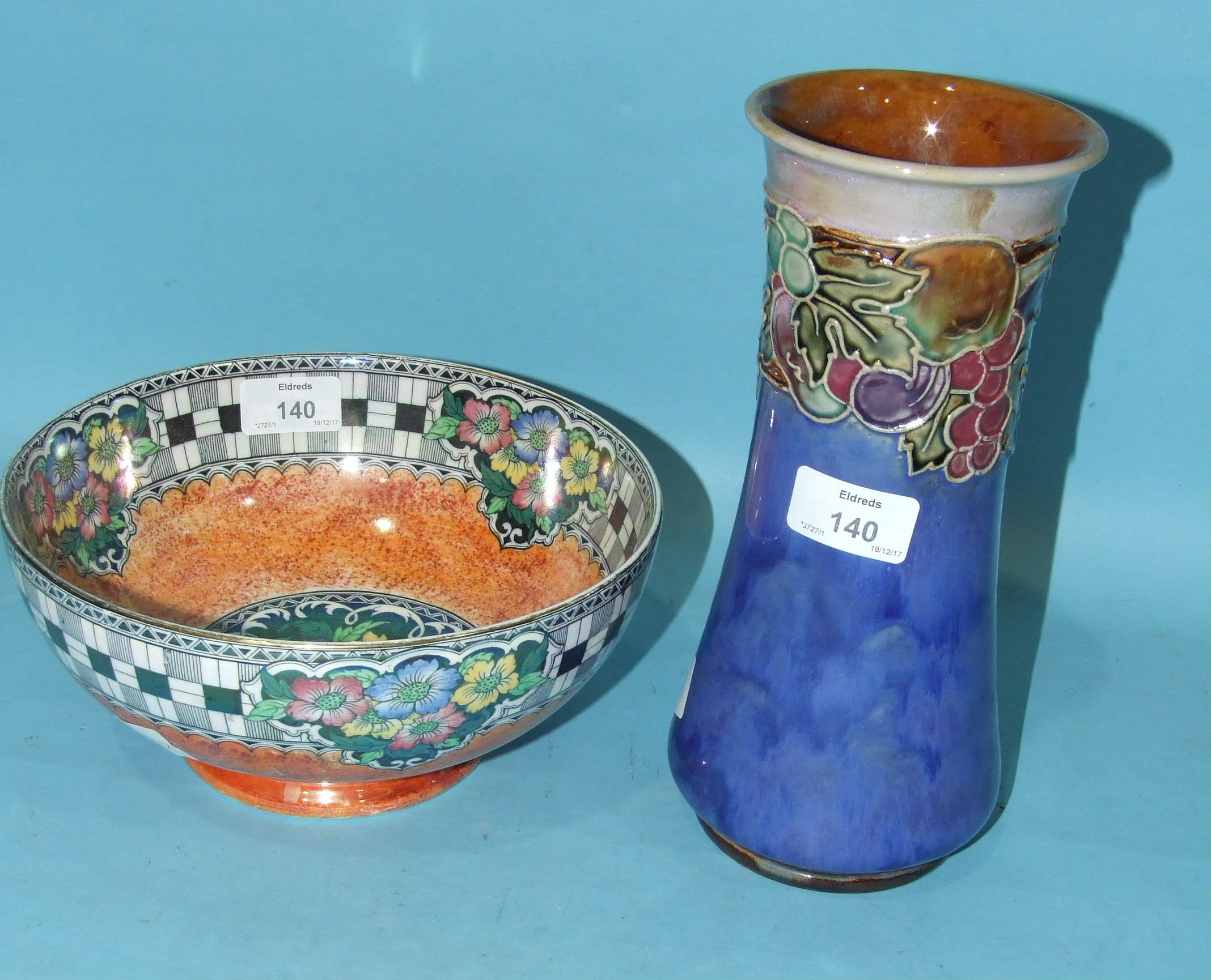 A Royal Doulton stoneware vase of waisted form with tubeline decoration of fruit on a mottled