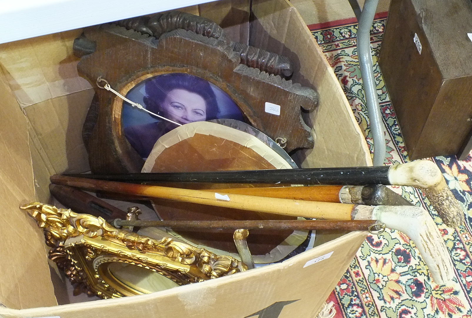 Two horn-handled walking sticks, a pair of oak mirror/photo frames and other items.