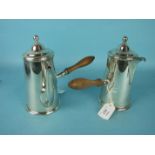 A pair of Edwardian silver coffee and hot water jugs, each with tapering body and turned wood