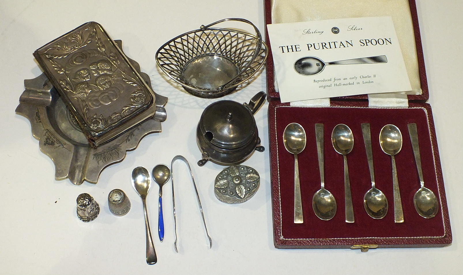 A set of six sterling silver Puritan spoons, cased, a sterling silver salt, an Asian white metal