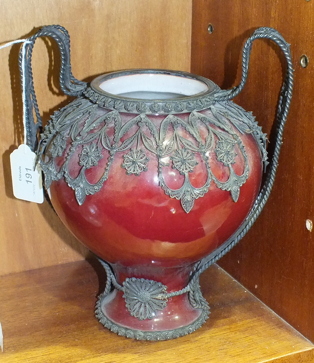 A glazed baluster pottery vase with overall silver filigree mount forming handles, 24cm high.