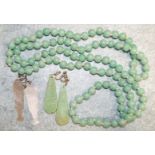 A string of simulated jade paste beads and two pairs of earrings.