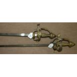 A pair of reproduction brass basket-hilted swords, (2).