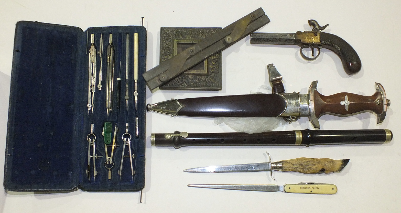 A World War II German SA dagger and sheath, a collection of drawing instruments and other items.