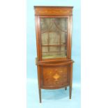 An Edwardian inlaid mahogany display cabinet, the upper section fitted with an astragal-glazed