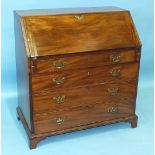 An early-19th century mahogany bureau, the fall front opening to reveal pigeon holes and drawers