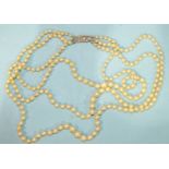 A necklace of three strings of graduated cultured pearls with 8/8-cut diamond set Art Deco clasp,