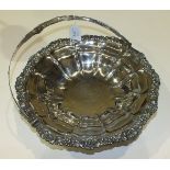 A George III silver swing handled cake basket of circular lobed form, inscription to centre, 32.