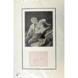Errol Flynn (1909-59) Australian Actor, a signed album page mounted with photograph, 13.5 x 20.5