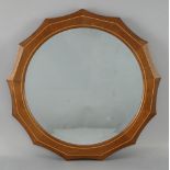 Edward Barnsley walnut wall mirror of shaped circular form with blond wood stringing, 40cm diameter.