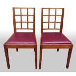 Cotswold school, four oak dining chairs after a design by Ernest Gimson, open lattice back, square