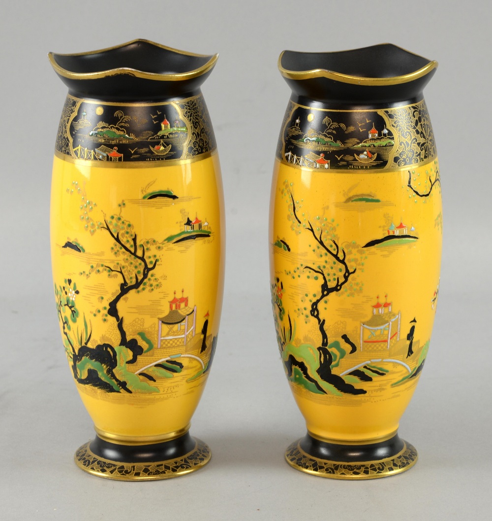 Pair of Carlton ware vases, with enamelled decoration of an Oriental scene on a yellow ground vases,